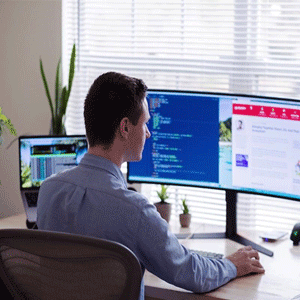 A man works on relationship mapping tools and software on his computer.